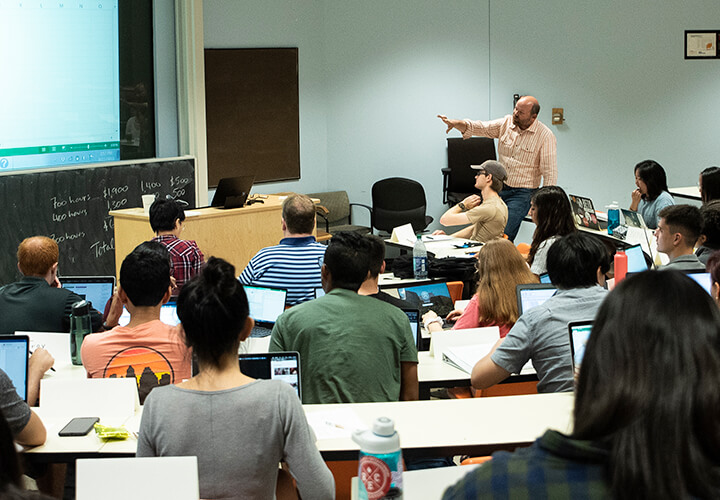 Professor speaks at front of lecture hall