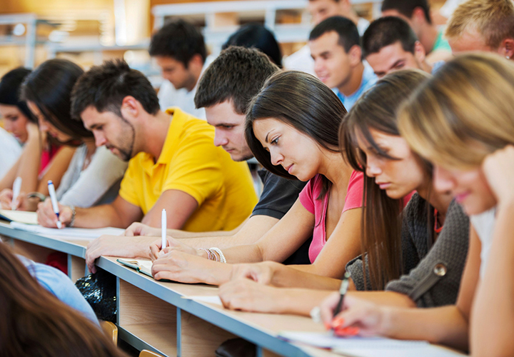 Group of students take notes in class