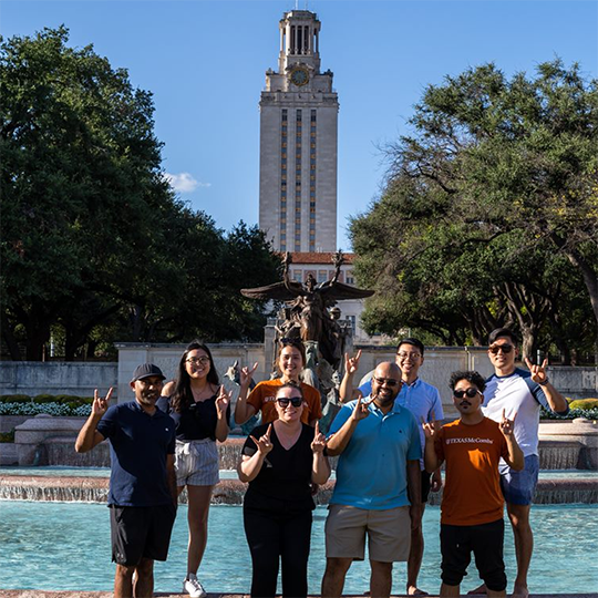 group of MBA students posing in front of Littlefield fountain