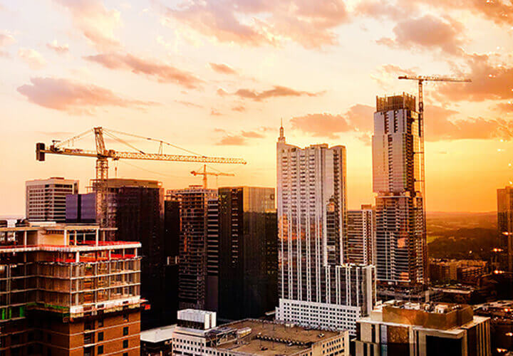 Austin city buildings and cranes at sunset