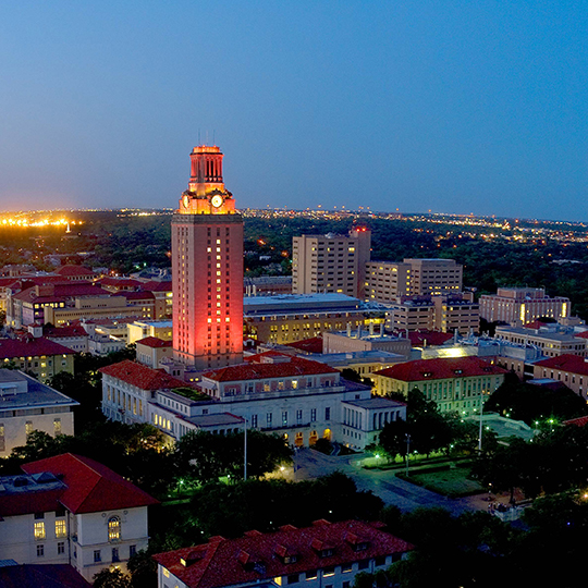 University of Texas tower illuminated in orange light