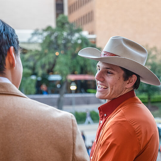 Smiling student in cowboy hat