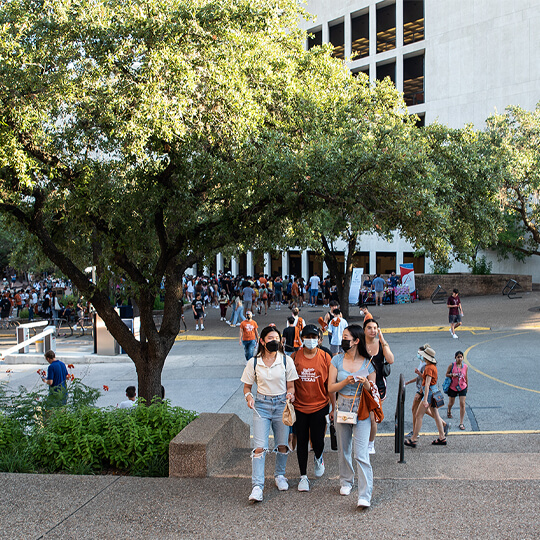 Masked students walking on campus during Gone to Texas event