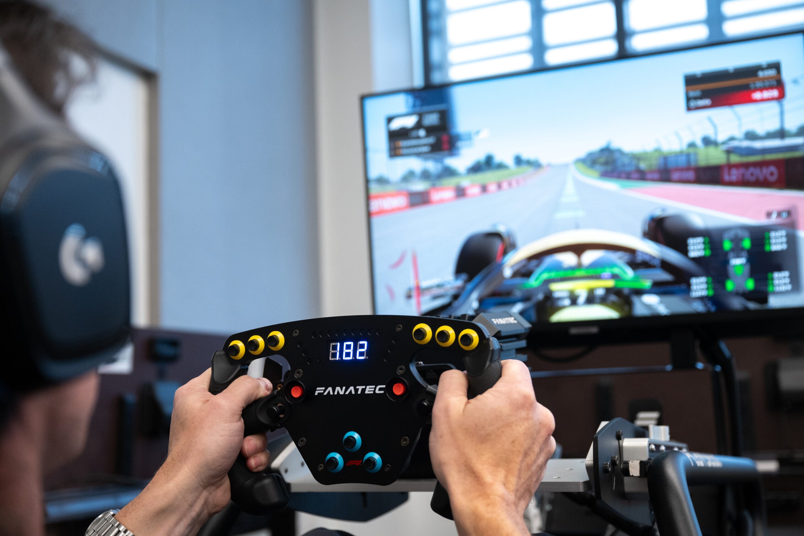 Person driving a car simulator